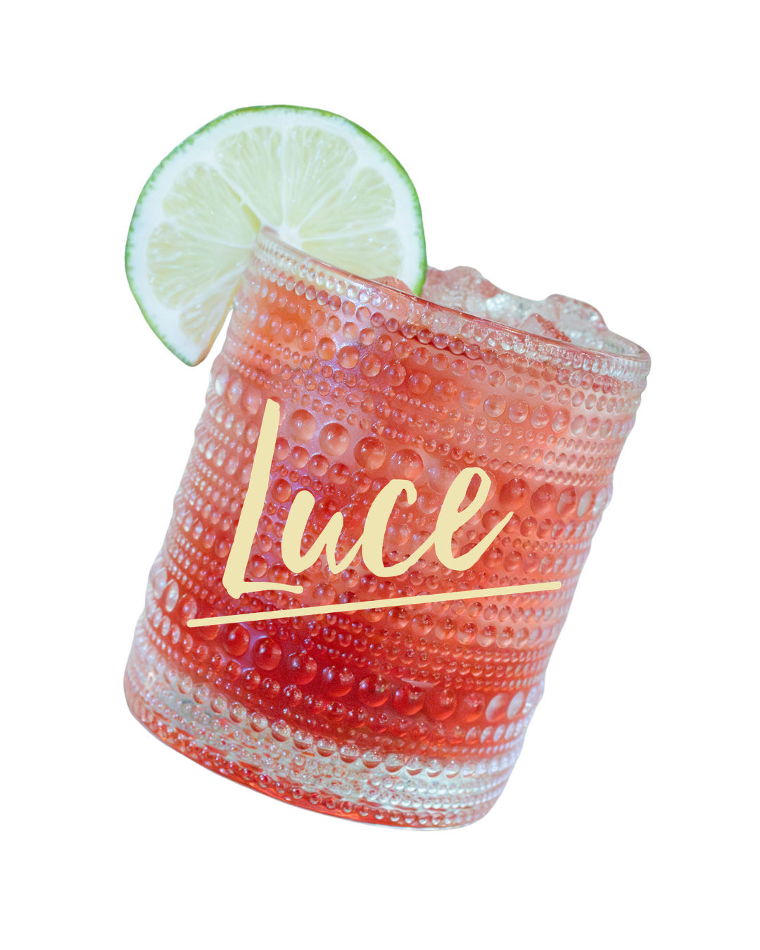Lime-garnished red cocktail in a textured glass labeled “Luce”