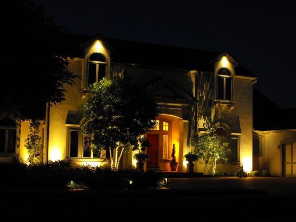 The front of a house is lit up at night