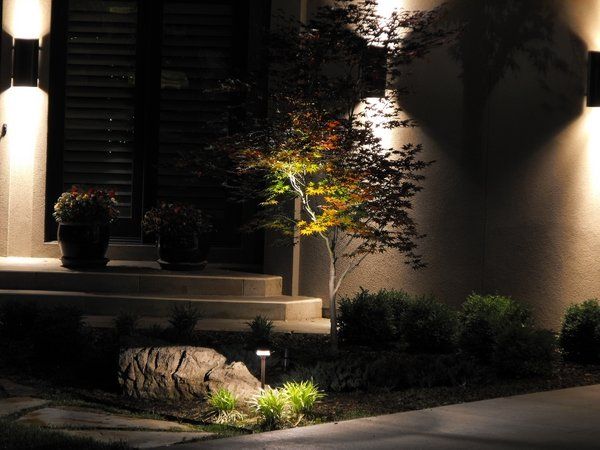 The front of a house is lit up at night