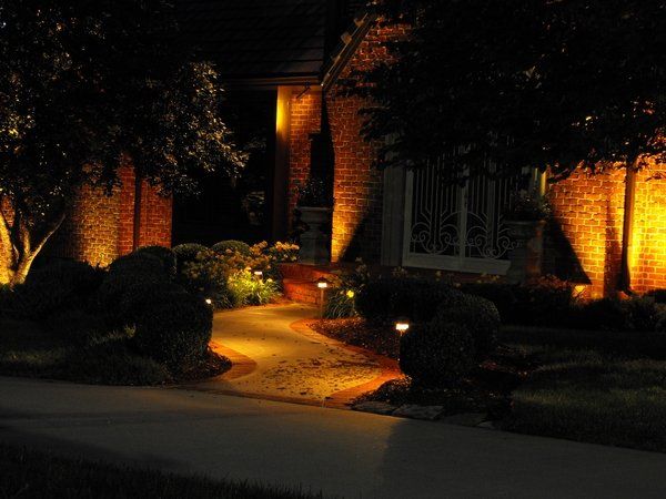 The front of a house is lit up at night.