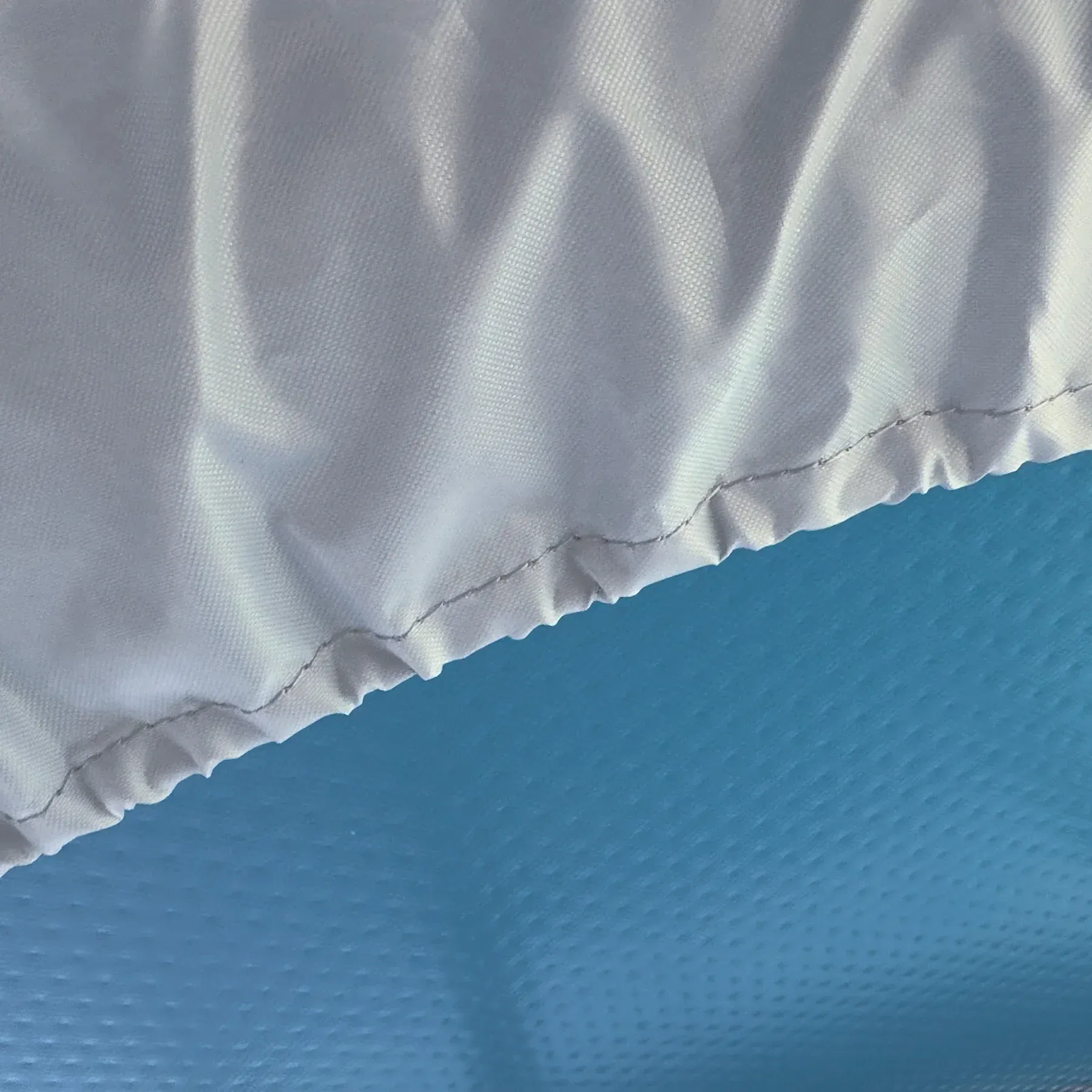 A close up of a white cloth on a blue surface