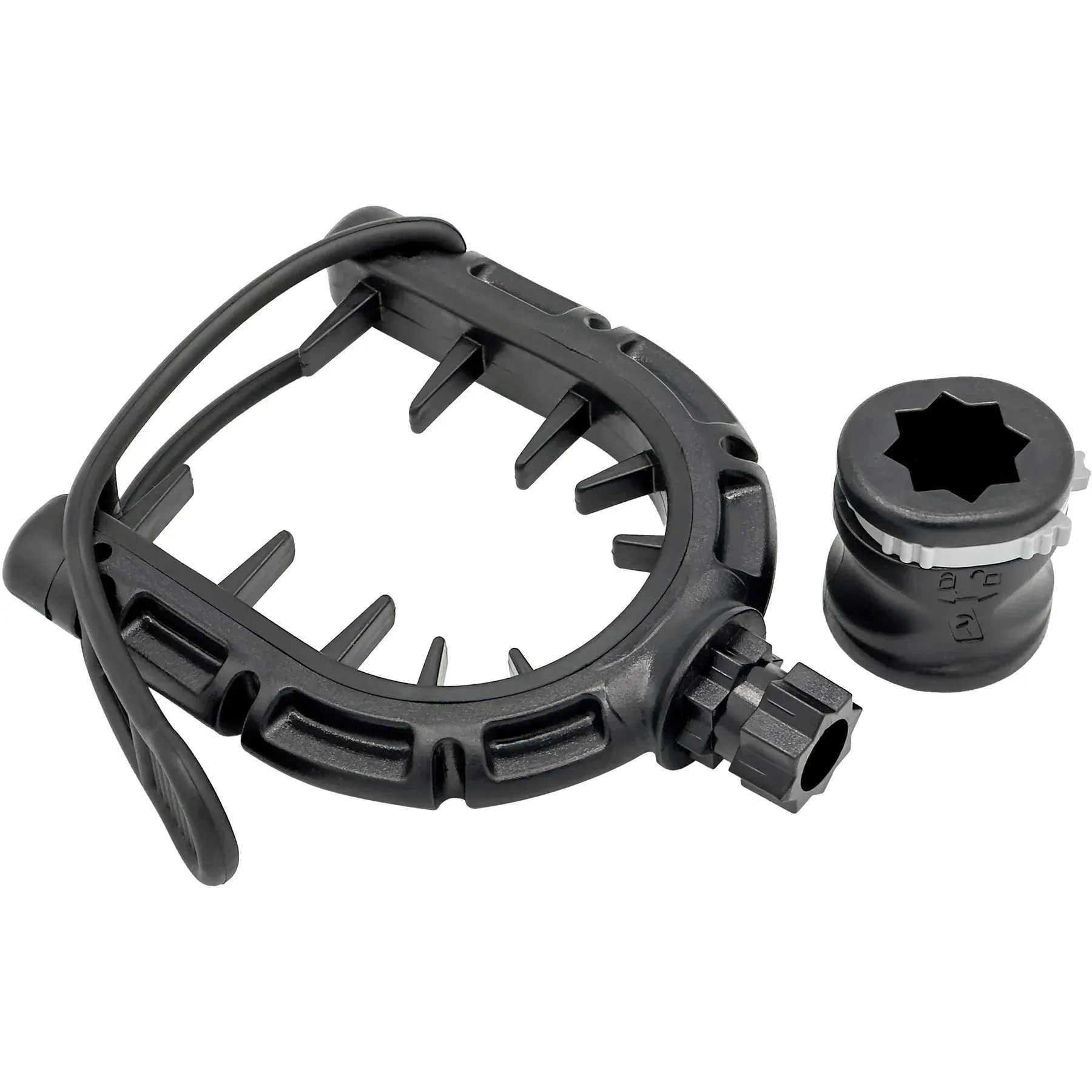 A close up of a black plastic object on a white background.