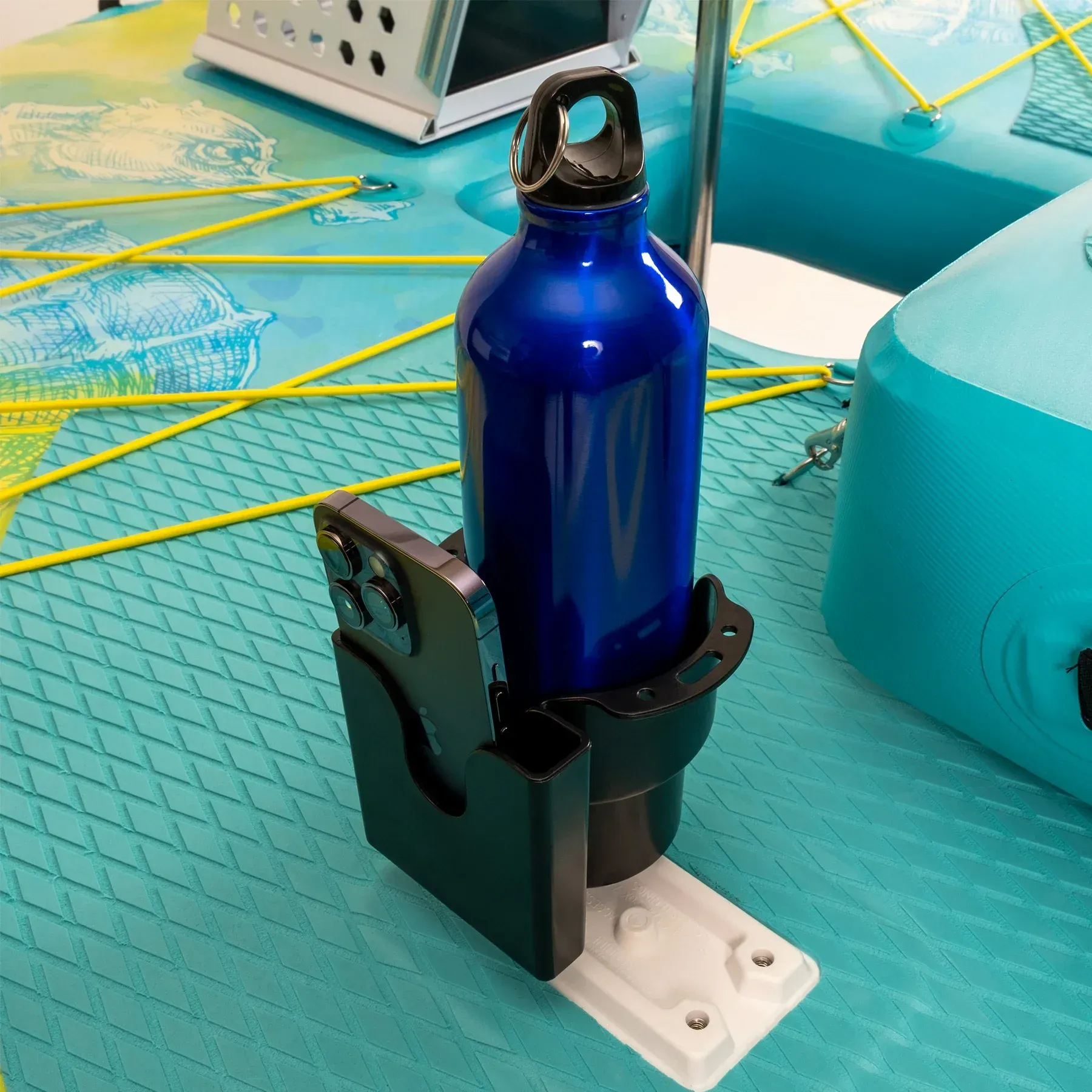 A blue water bottle is sitting in a holder on a paddle board