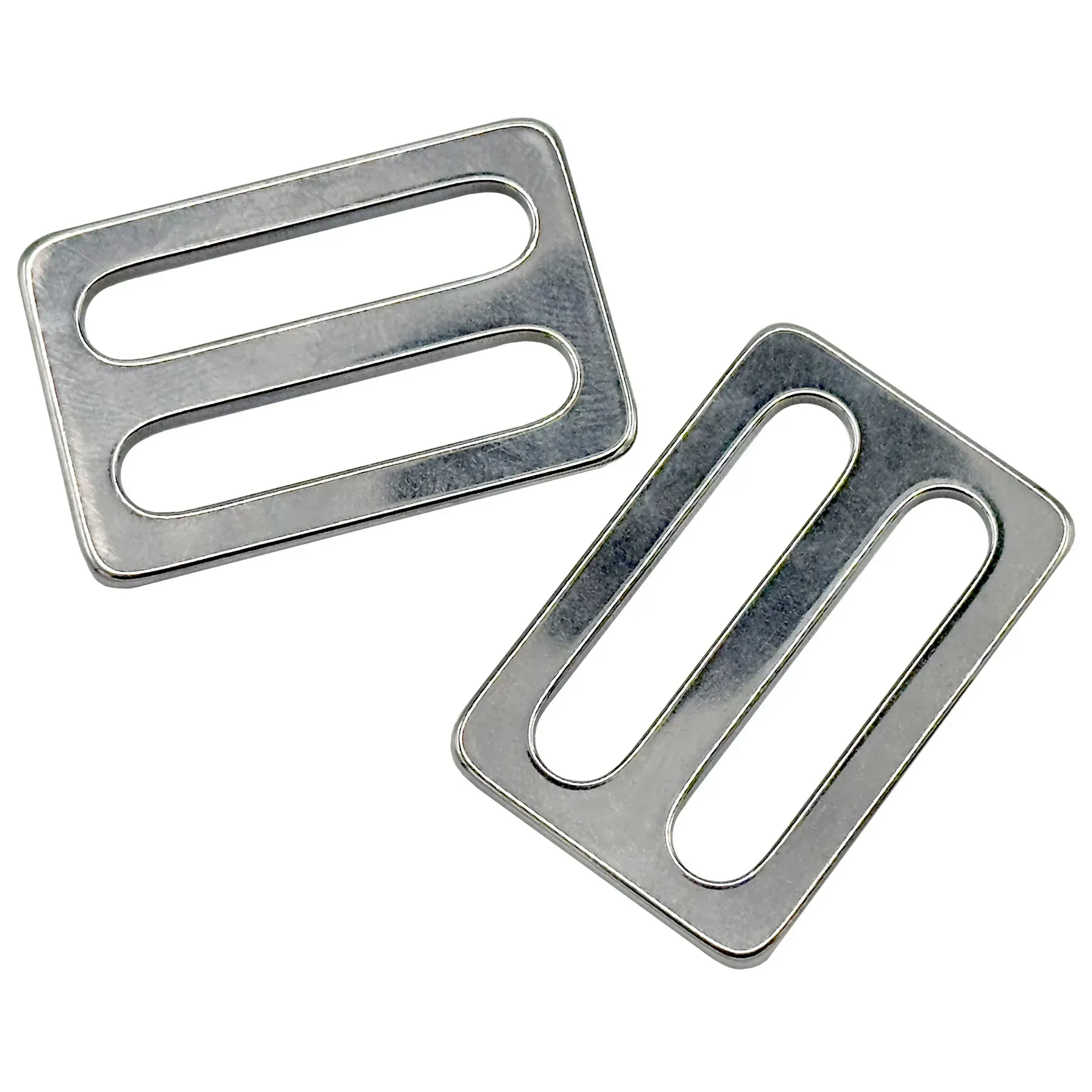 A pair of metal buckles with two holes in them on a white background.