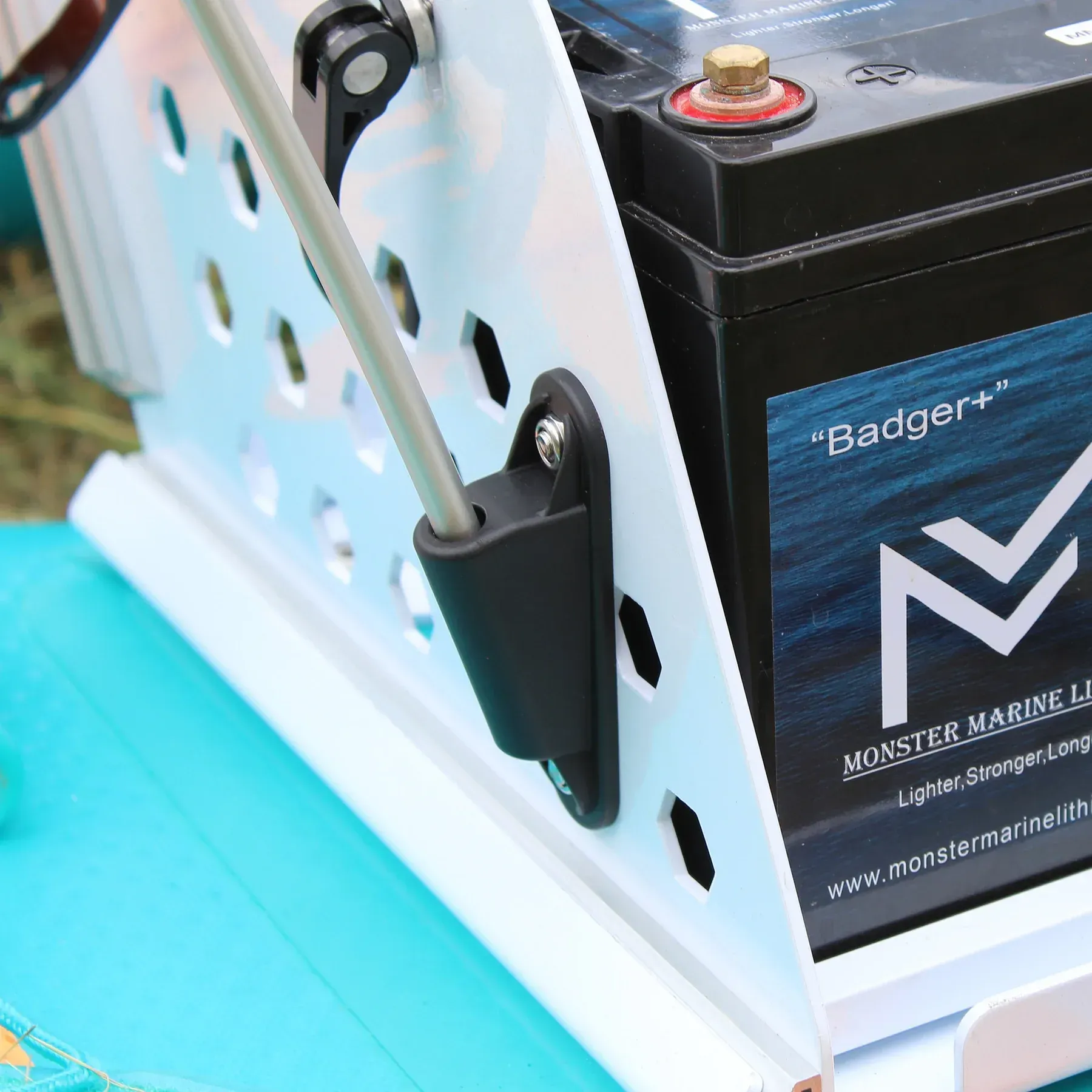 A badger battery is attached to a white cage