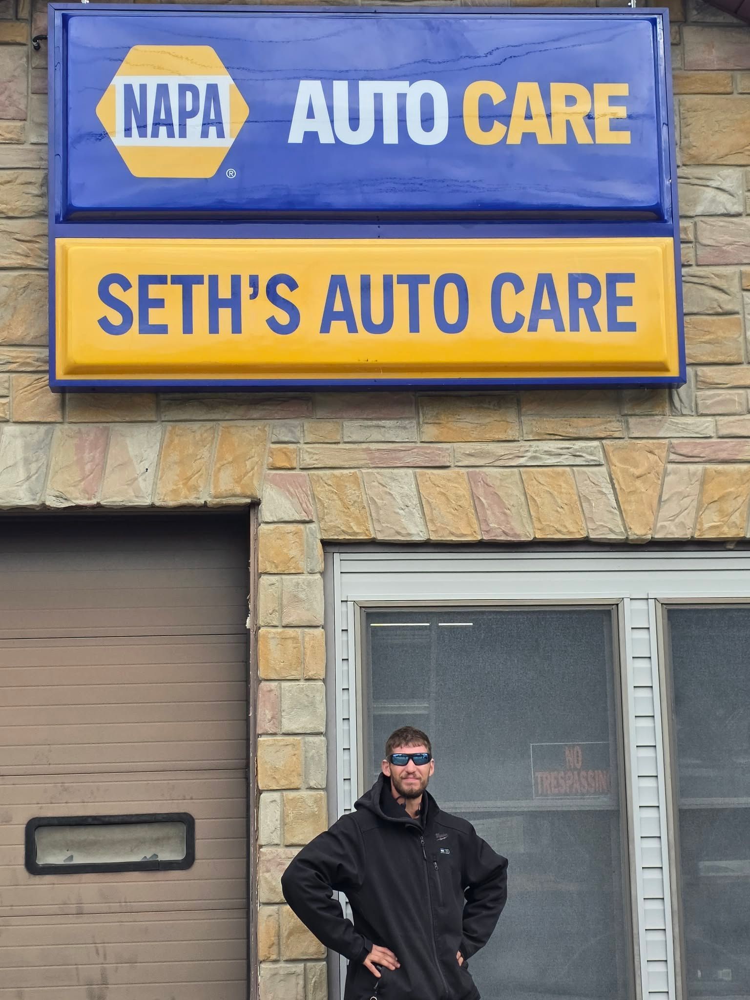 Man standing in front of Seth's Auto Care, a NAPA Auto Care shop. | Seth's Auto Care