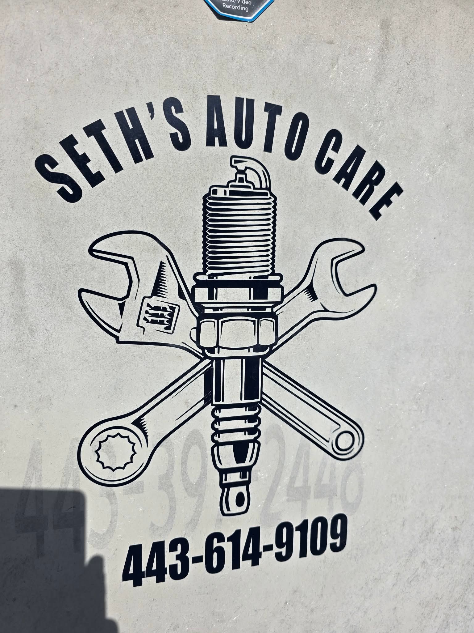 Seth's Auto Care logo with spark plug, wrenches, and phone number 443-614-9109. | Seth's Auto Care