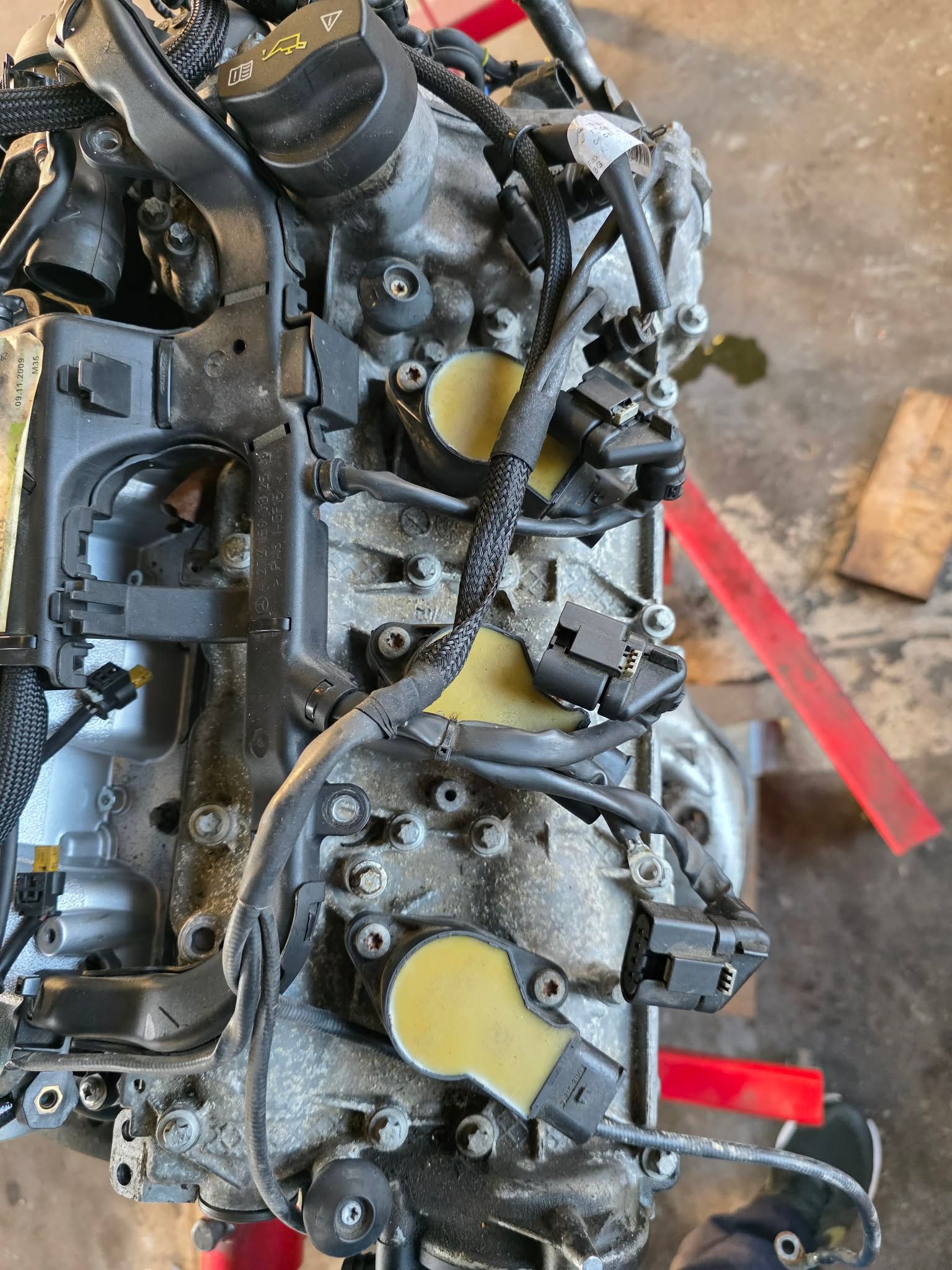 Engine with visible spark plugs, wiring, and components; a mechanical close-up shot. | Seth's Auto Care