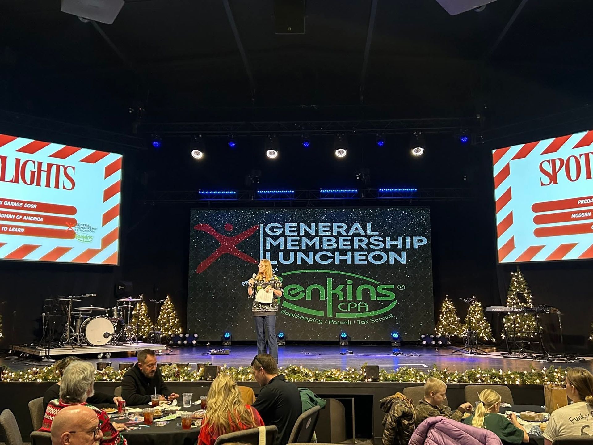 Woman speaking on stage at a 