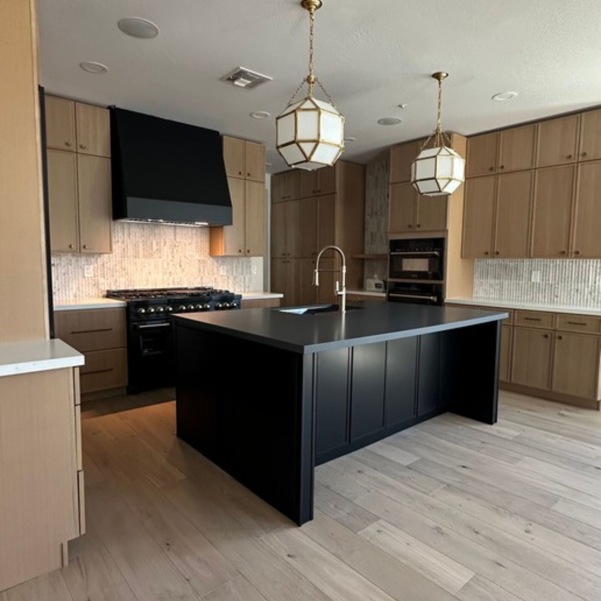 A kitchen counter with a vase of flowers on it