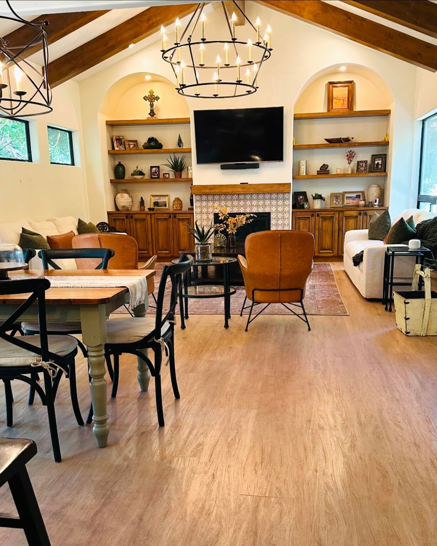 A living room with a table and chairs and a fireplace.