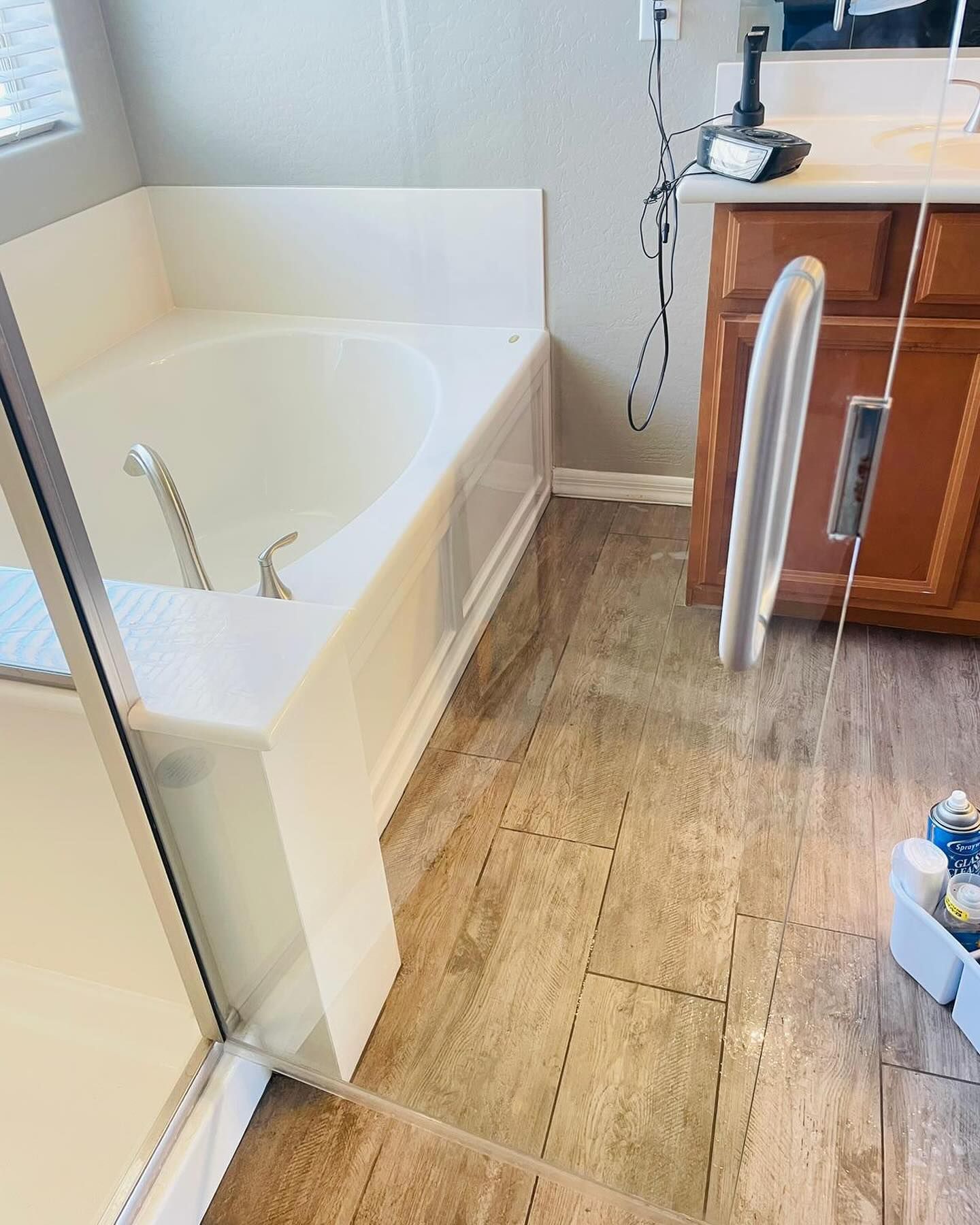 A bathroom with a tub , sink , and mirror.