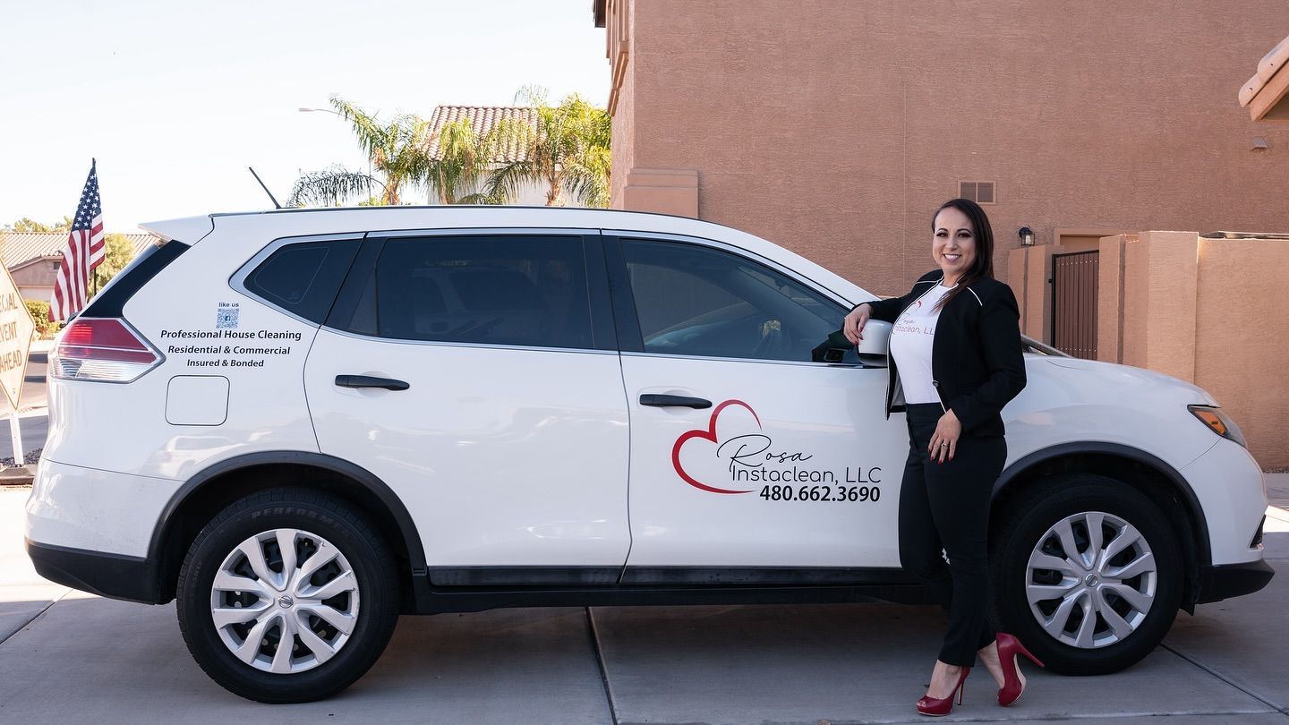 A woman is standing next to a white suv.
