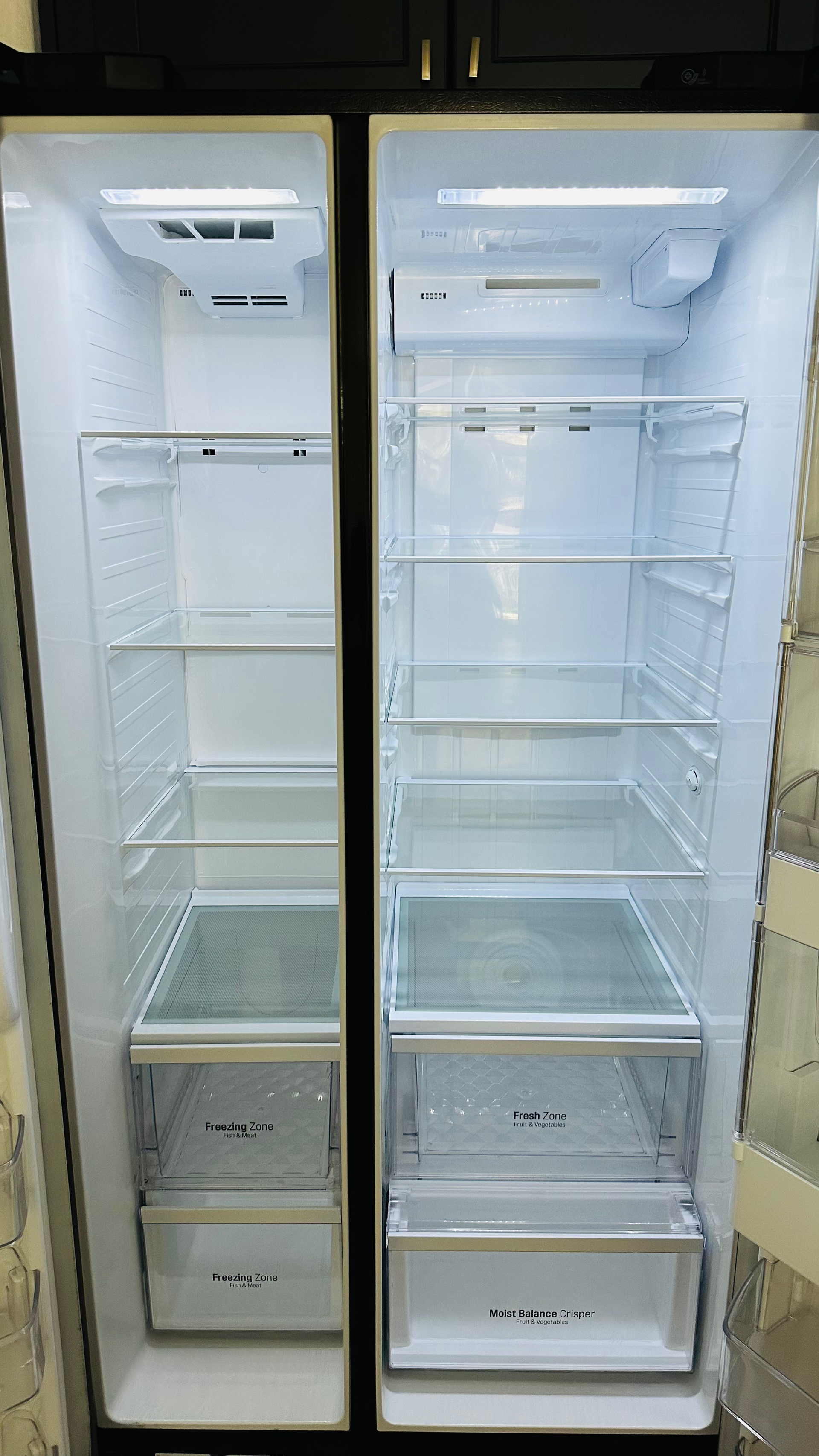 The inside of an empty refrigerator with the door open.