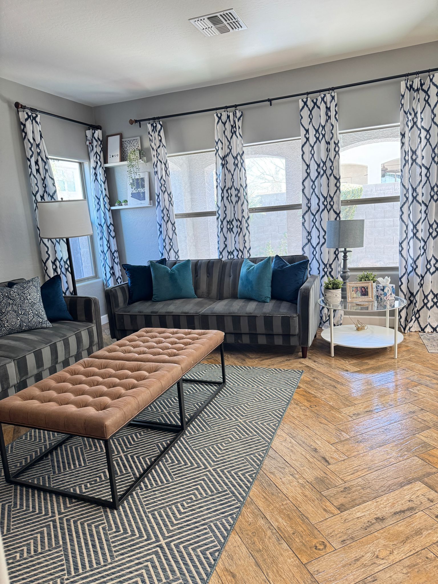 A living room with a couch , coffee table , and rug.