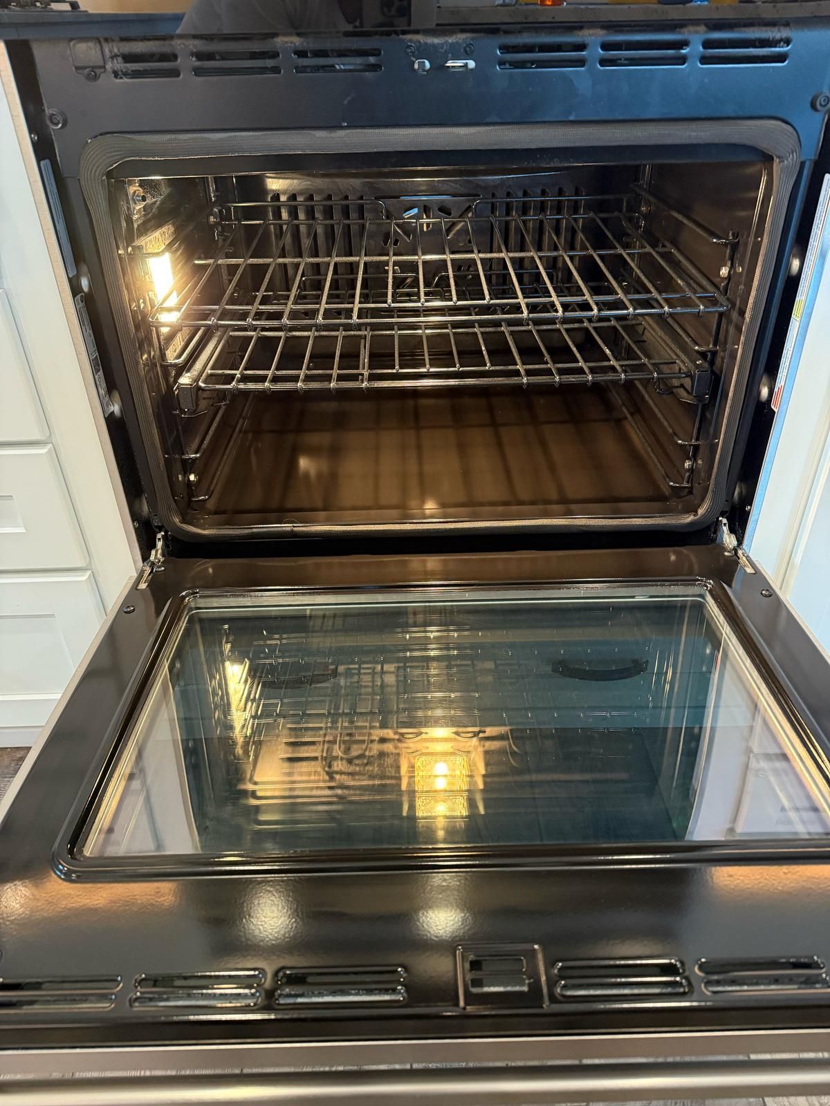 The inside of an oven is shown with the door open.