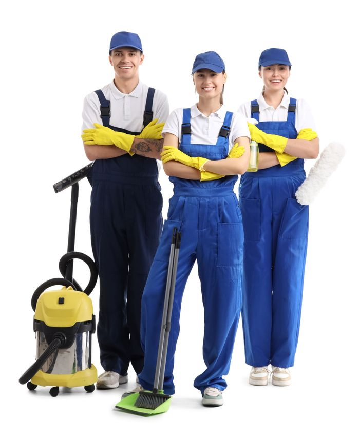A group of cleaners standing next to each other with their arms crossed.