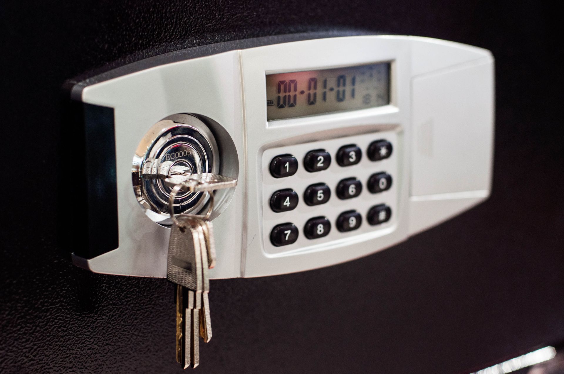 A close up of a digital safe with keys in it.