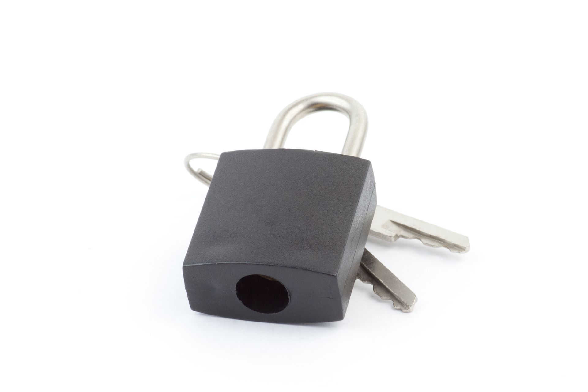 A black padlock and two keys on a white background