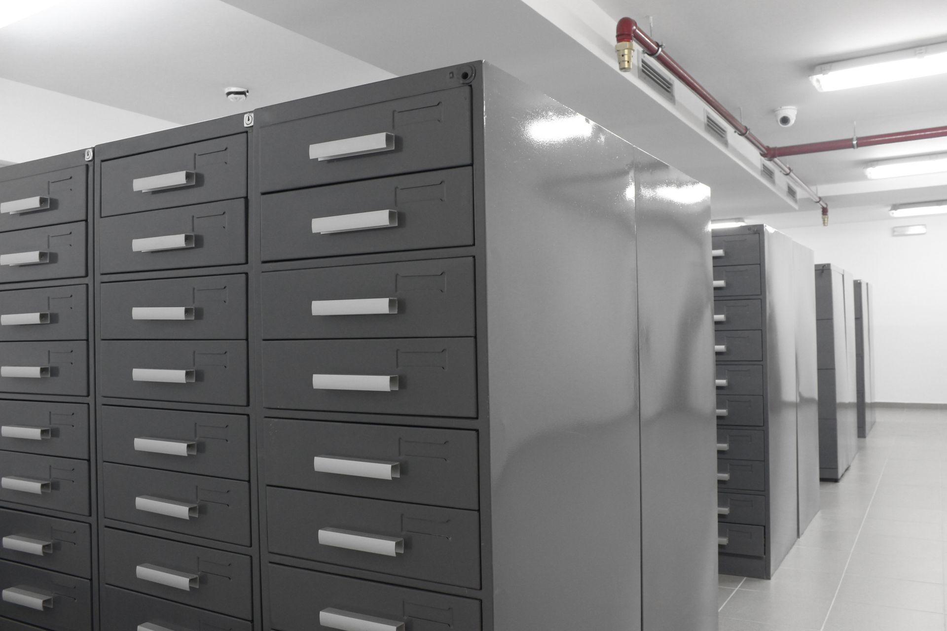 A row of filing cabinets are lined up in a room.