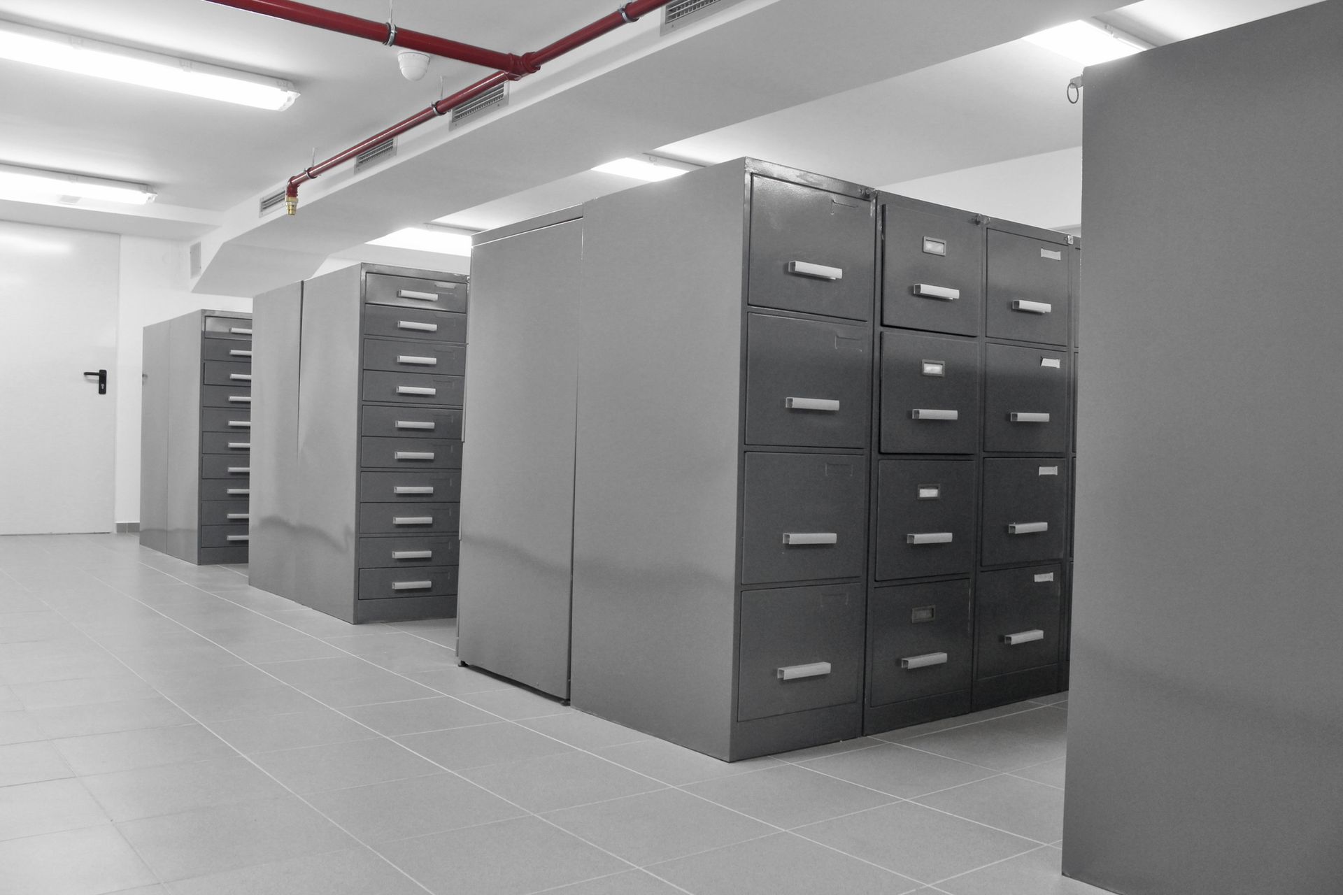 A row of filing cabinets are lined up in a room.