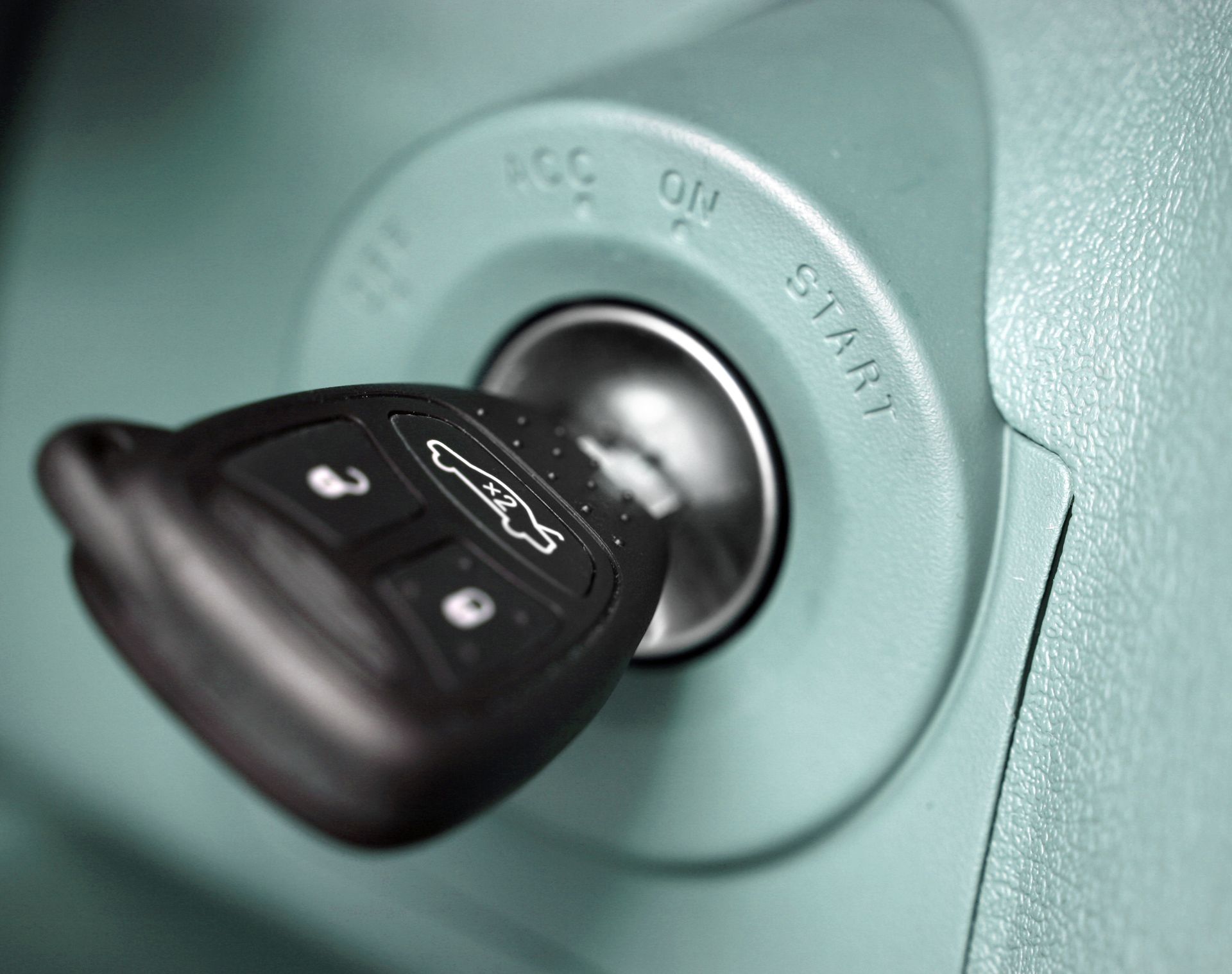 A car key is inserted into the ignition of a car