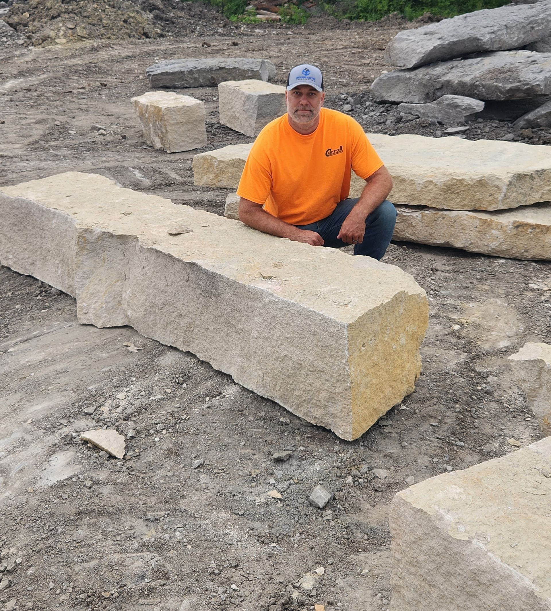 Rough Cuts Construction using a long tool to level and smooth out concrete underneath a deck.