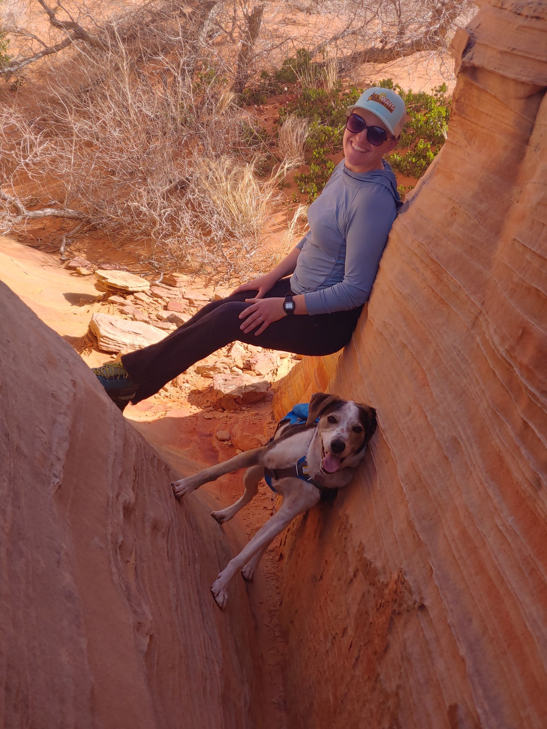 Jillian & Wren are stemming in a slot canyon by pressing their legs into one canyon wall and their backs into the other