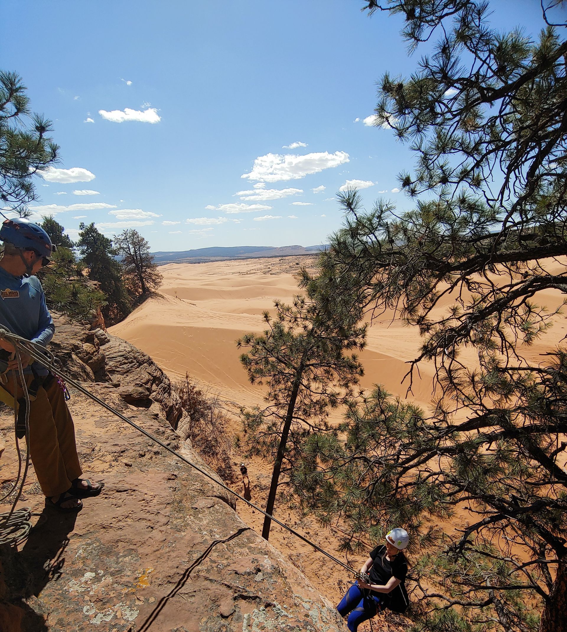 A man and a woman are posing for a picture in a canyon