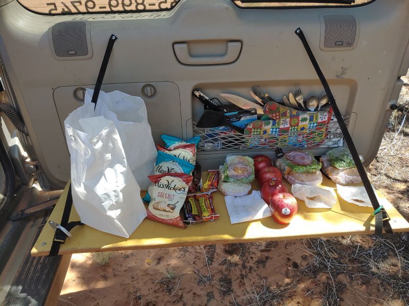 A bag of saltines sits on a table in the back of a car