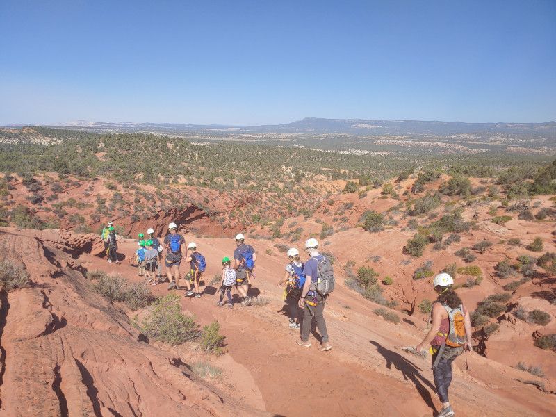 A group of people are hiking in the desert