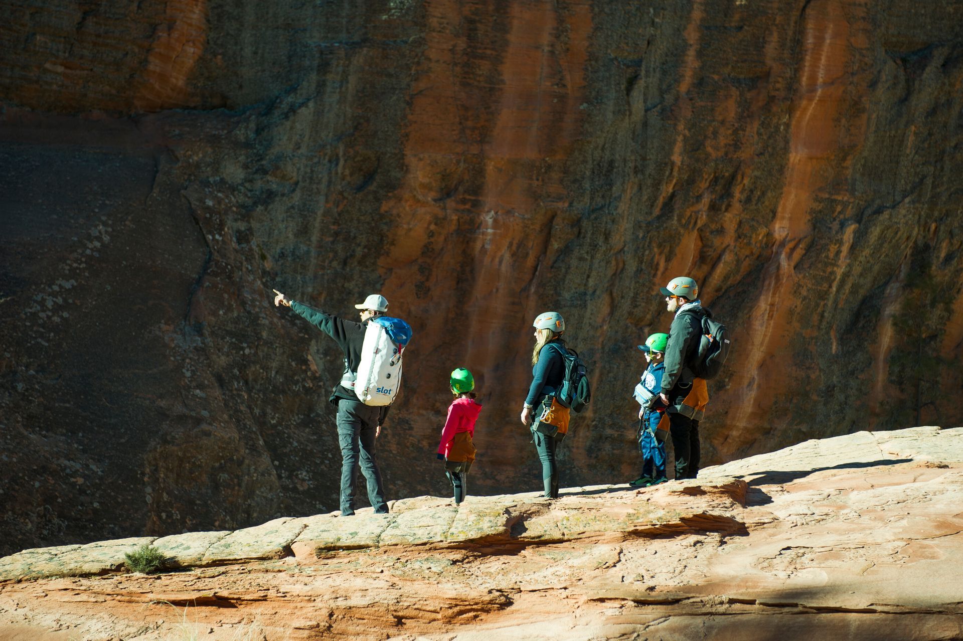 A shadow of a person is cast on a rocky cliff