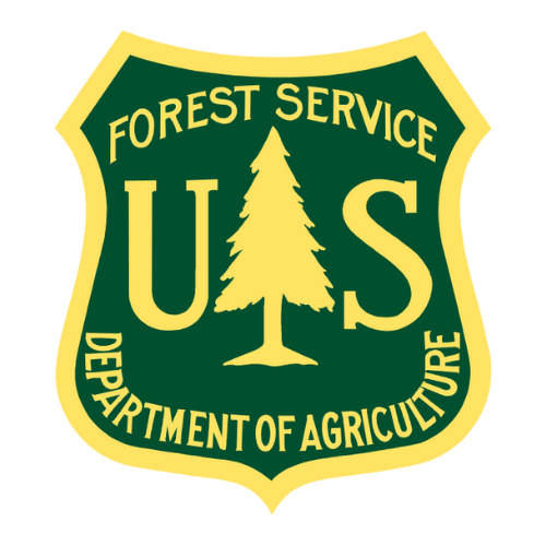 US Forest Service badge: dark green shield with yellow lettering and outline, featuring a stylized pine tree and