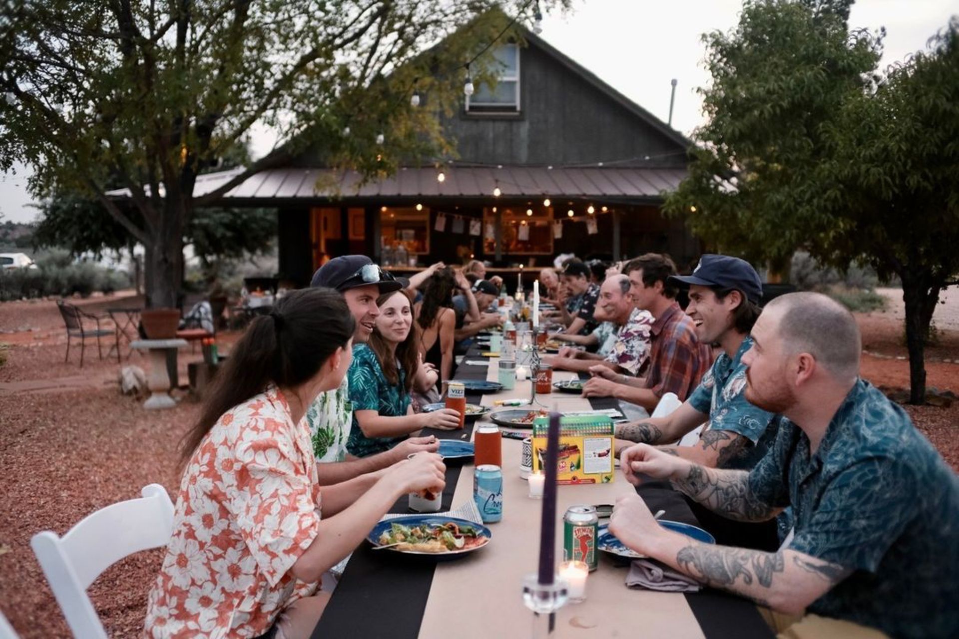 a group of people sitting at a table eating at a reception 