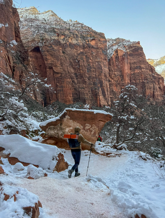 a person standing in the snow on a mountain