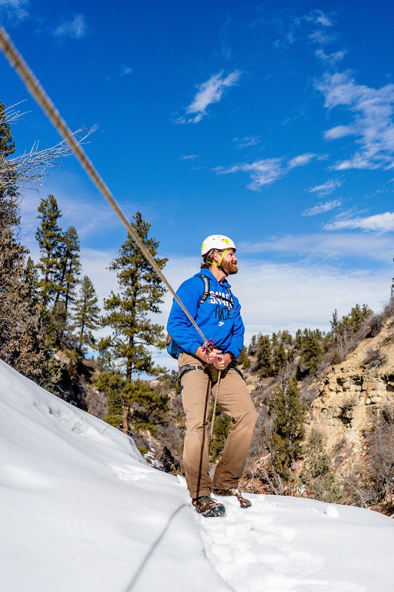 A man enjoying winter canyoneering in Birch Hollow