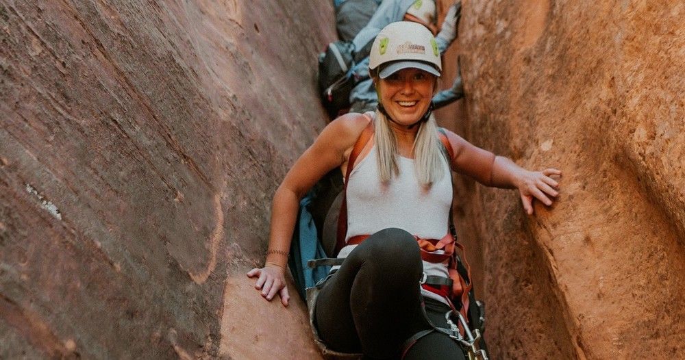 a woman coming down a canyon