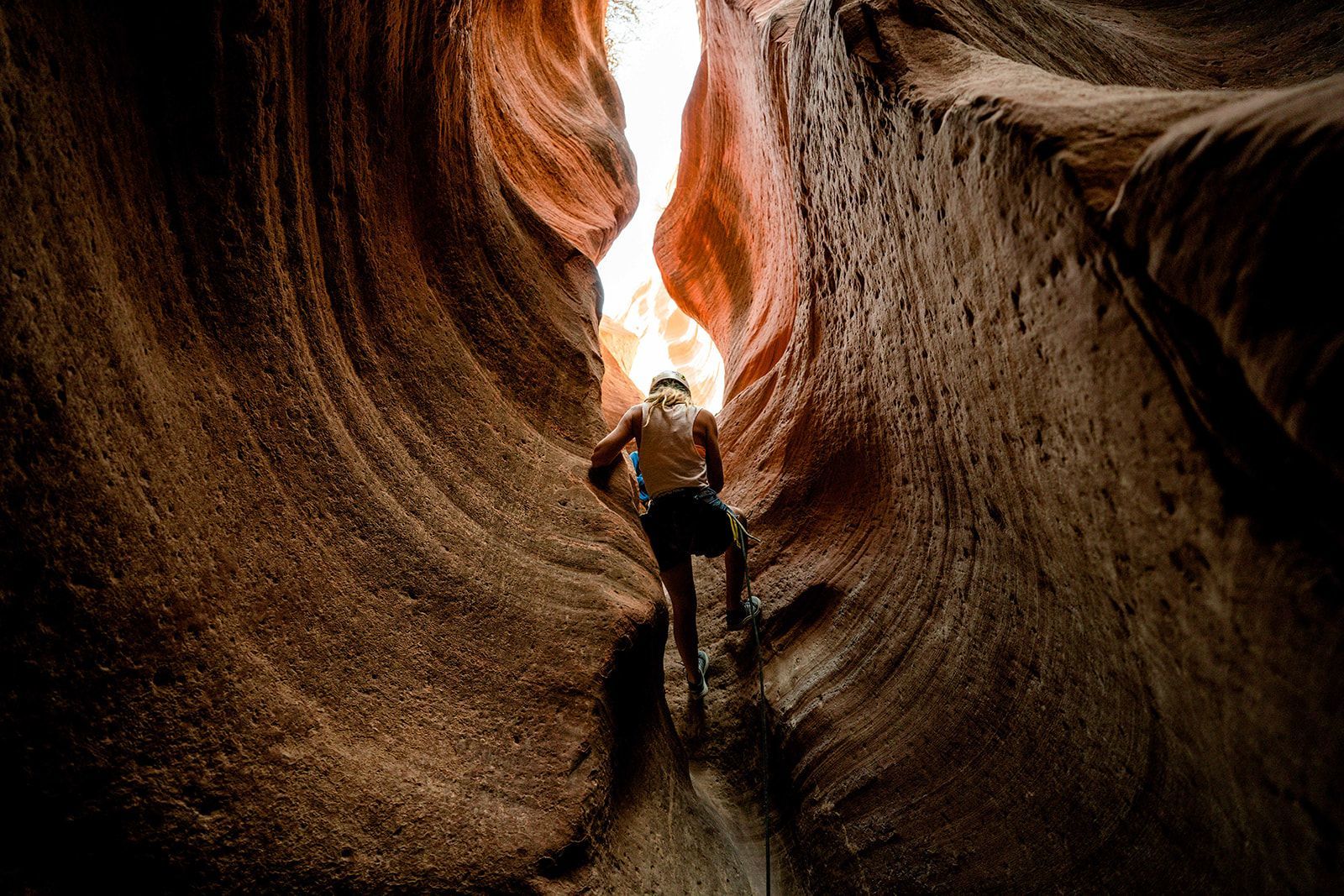 A man is standing in the middle of a canyon.