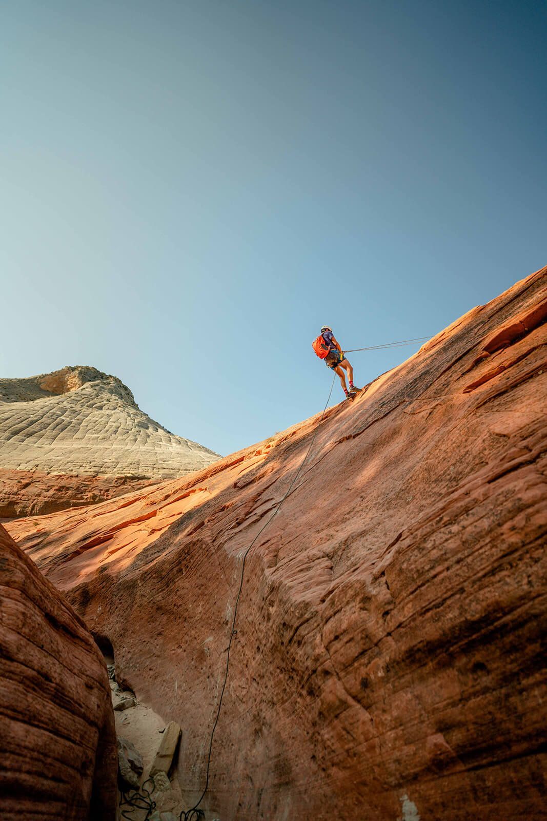 A Man Is Climbing up A Rock Wall