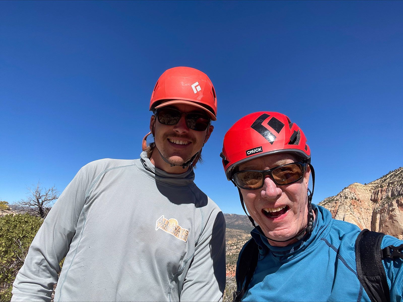 Nathan and customer wearing helmets and sunglasses are posing for a picture