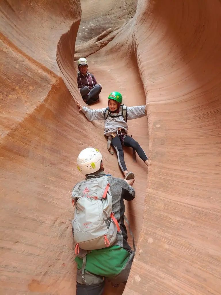 A group of people are sliding down a canyon.