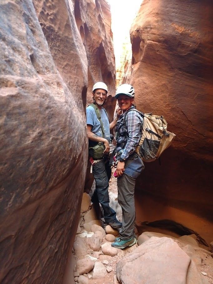A man and a woman are standing next to each other in a canyon.