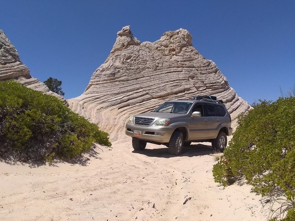 Car on the dirth road desert.