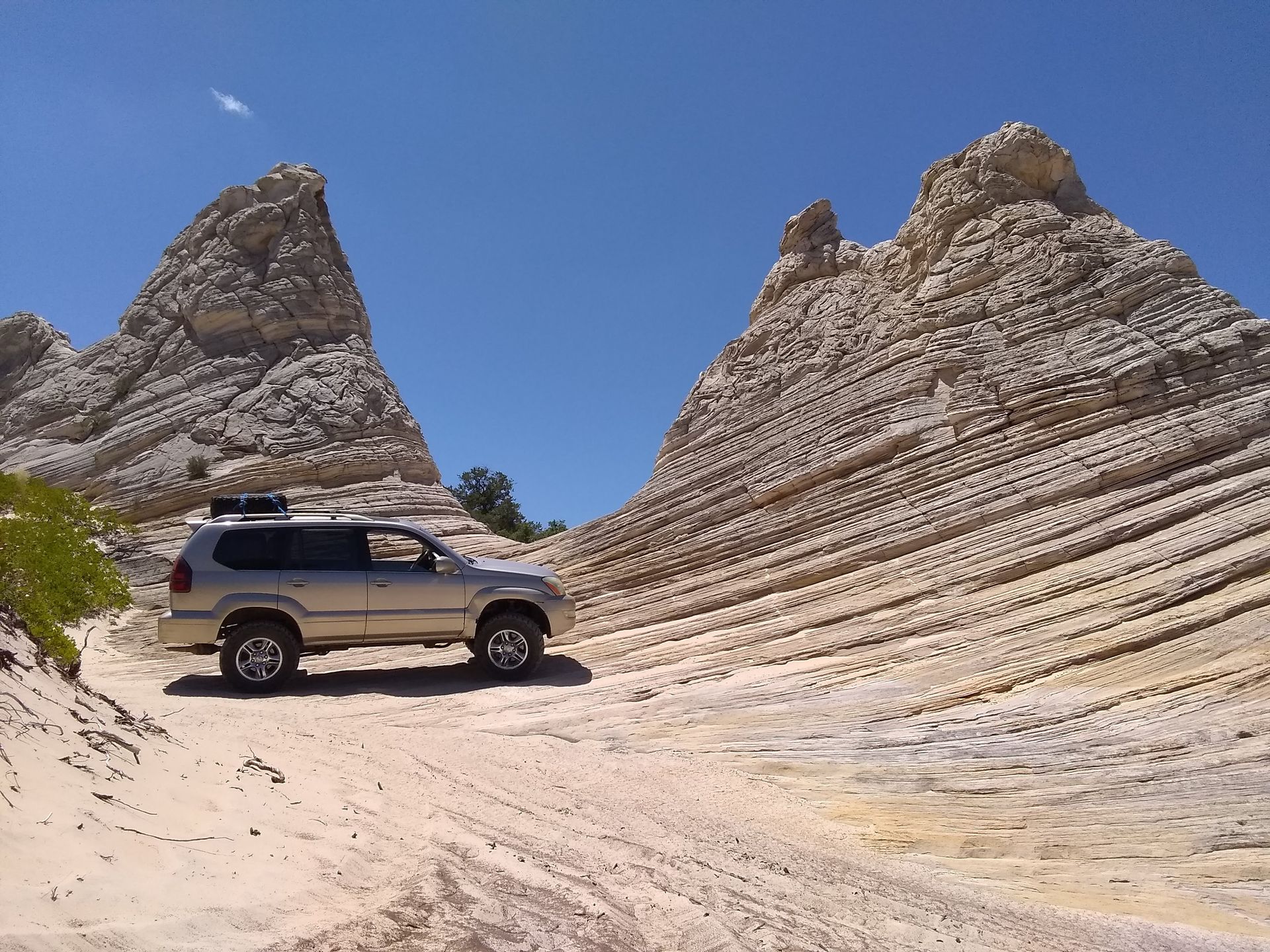 Off road vehicle parked next to white pinnacles