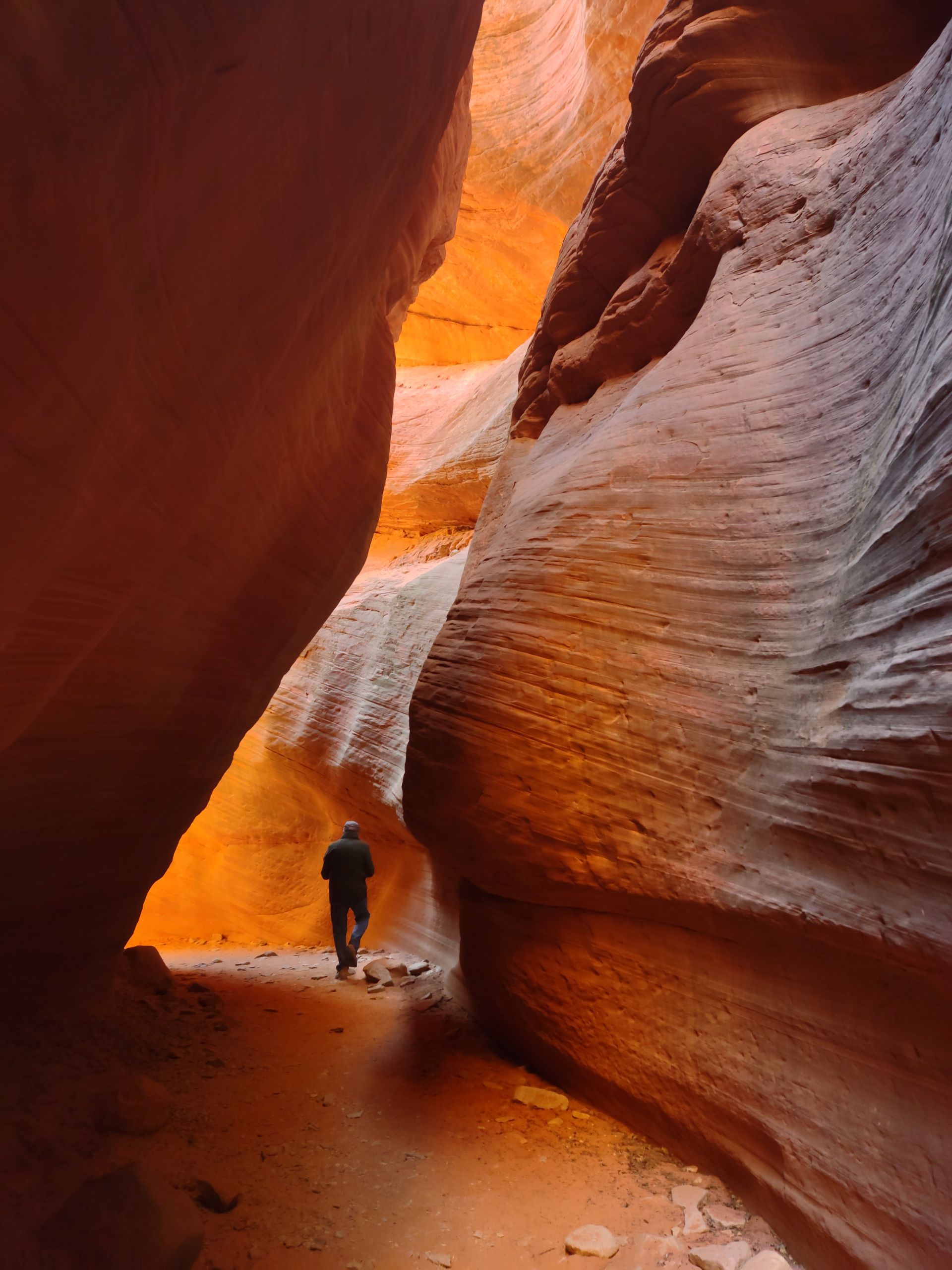 People walk through a slot canyon