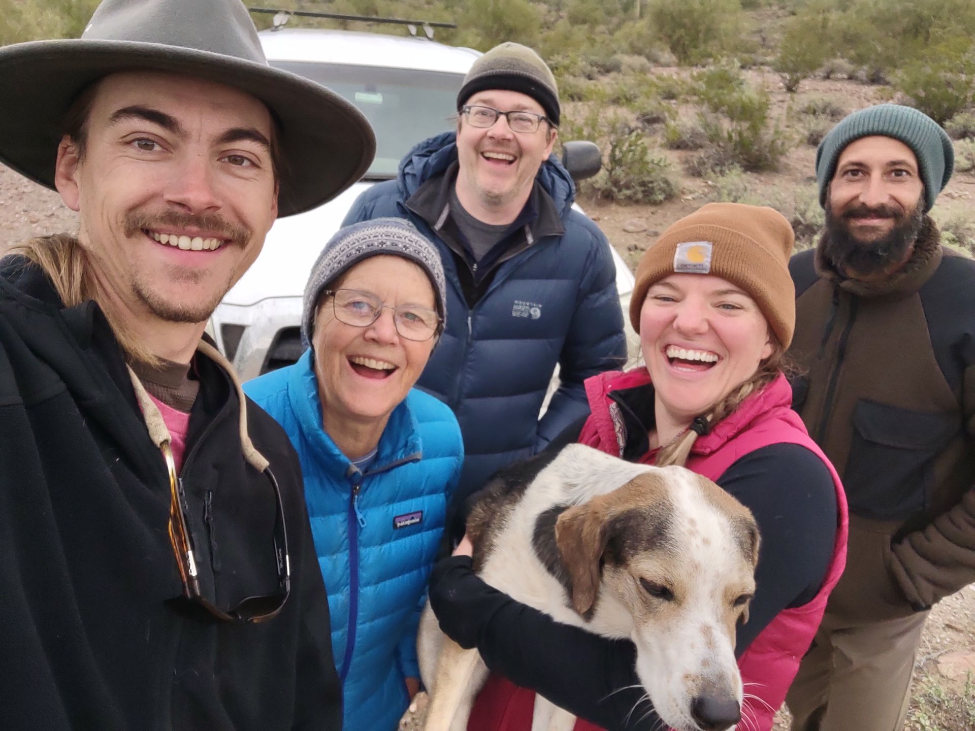 Nathan, Jillian, Wren and Darren are posing for a selfie wearing winter attire