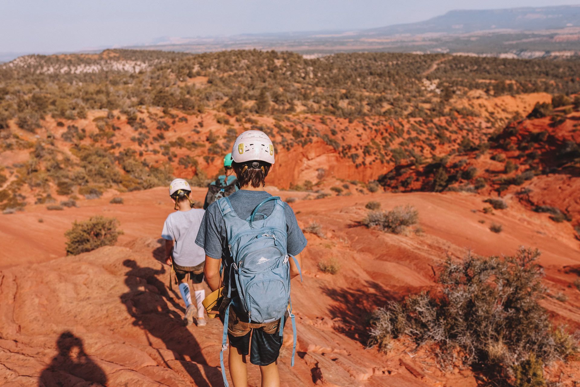 A man is standing in the middle of a canyon.