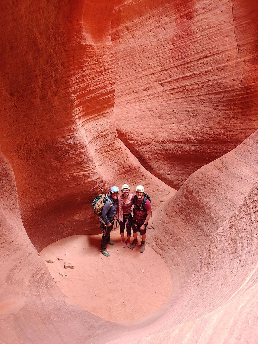 A group of people posing for a picture in a canyon