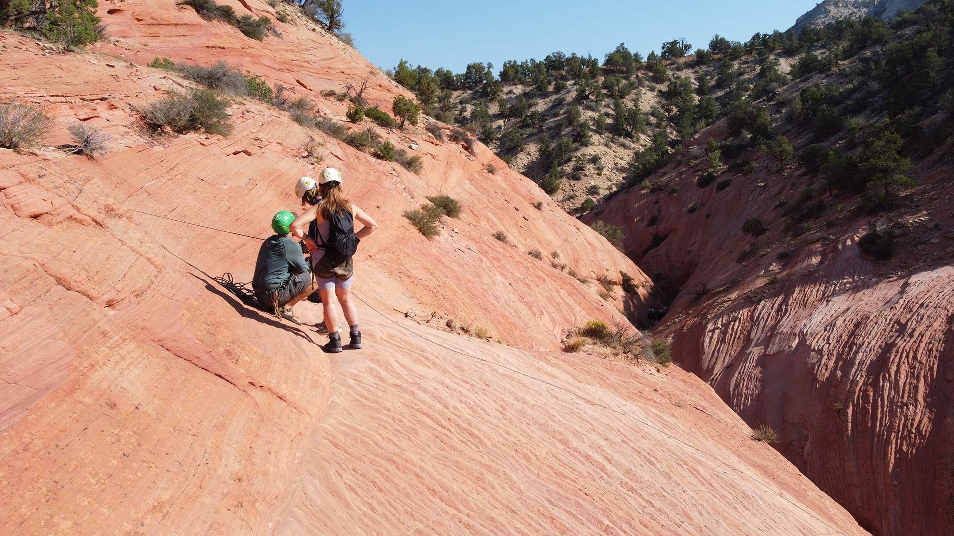 A man is standing in the middle of a canyon.