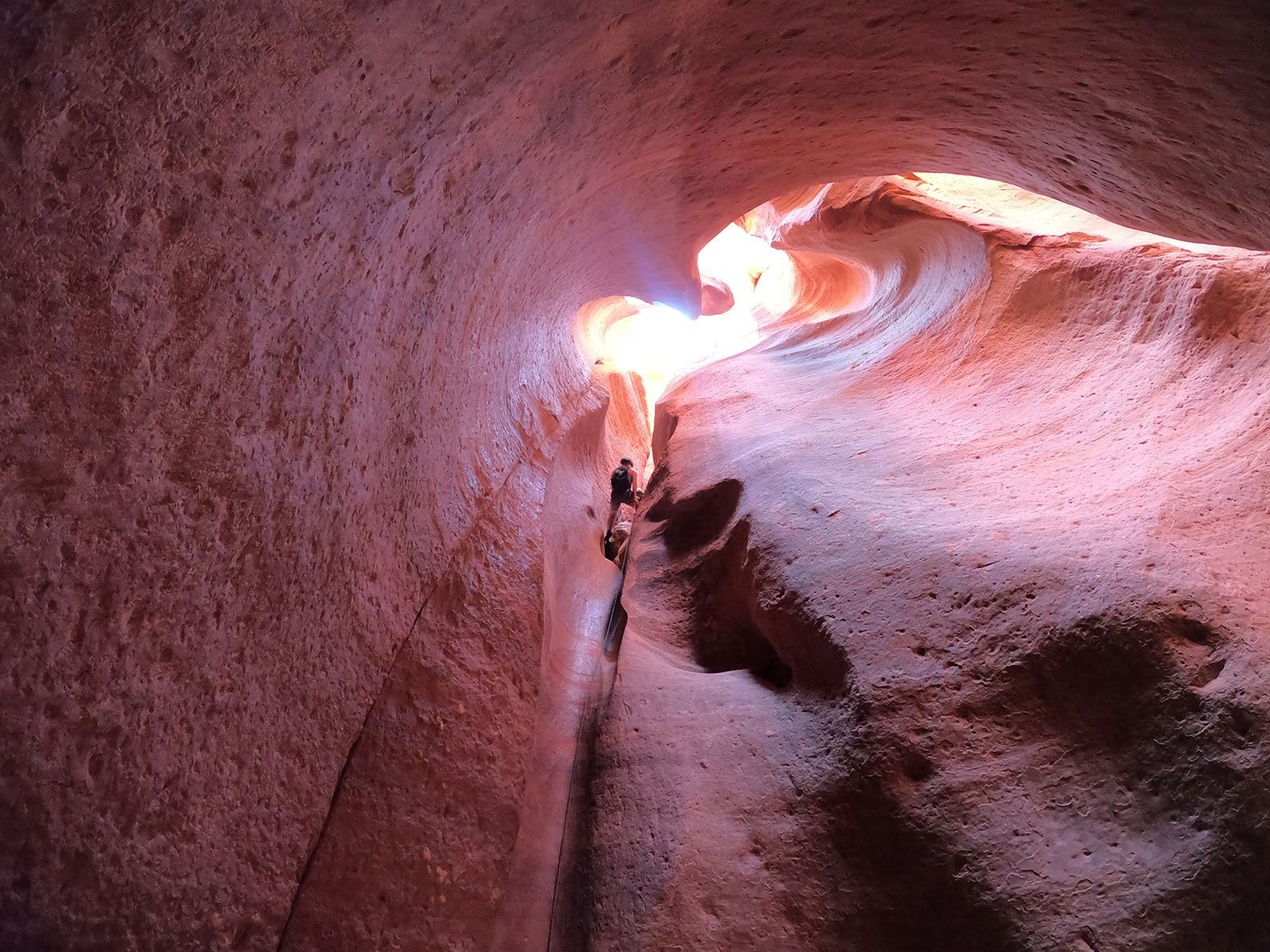 A cave with a light coming out of it